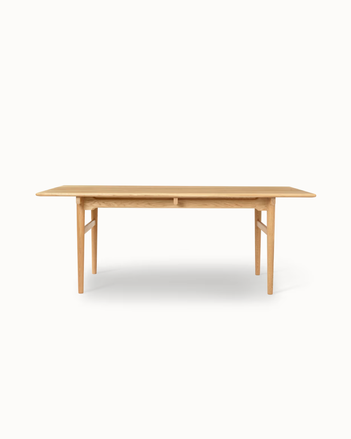 Samata solid teak dining table with oil-polished finish and tapered legs